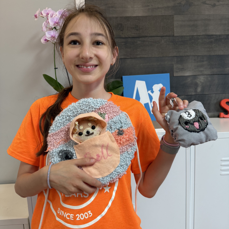A camper with her hand stitched projects.