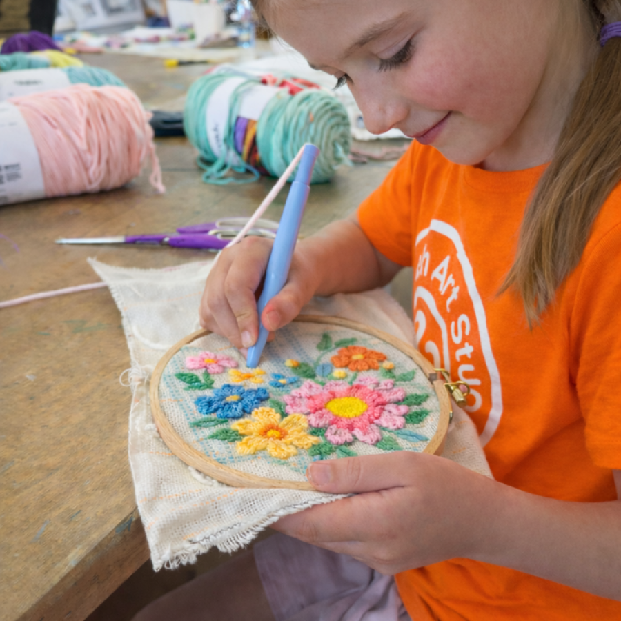 A camper working on her embroidery.