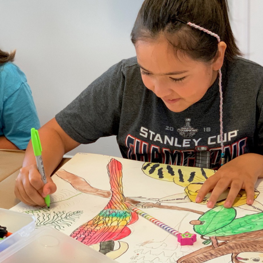 A camper working on her watercolor painting.